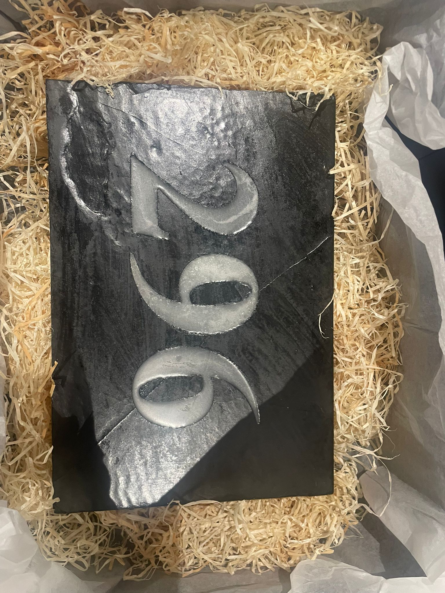 Welsh slate sign showing carved detail and reflective inlay