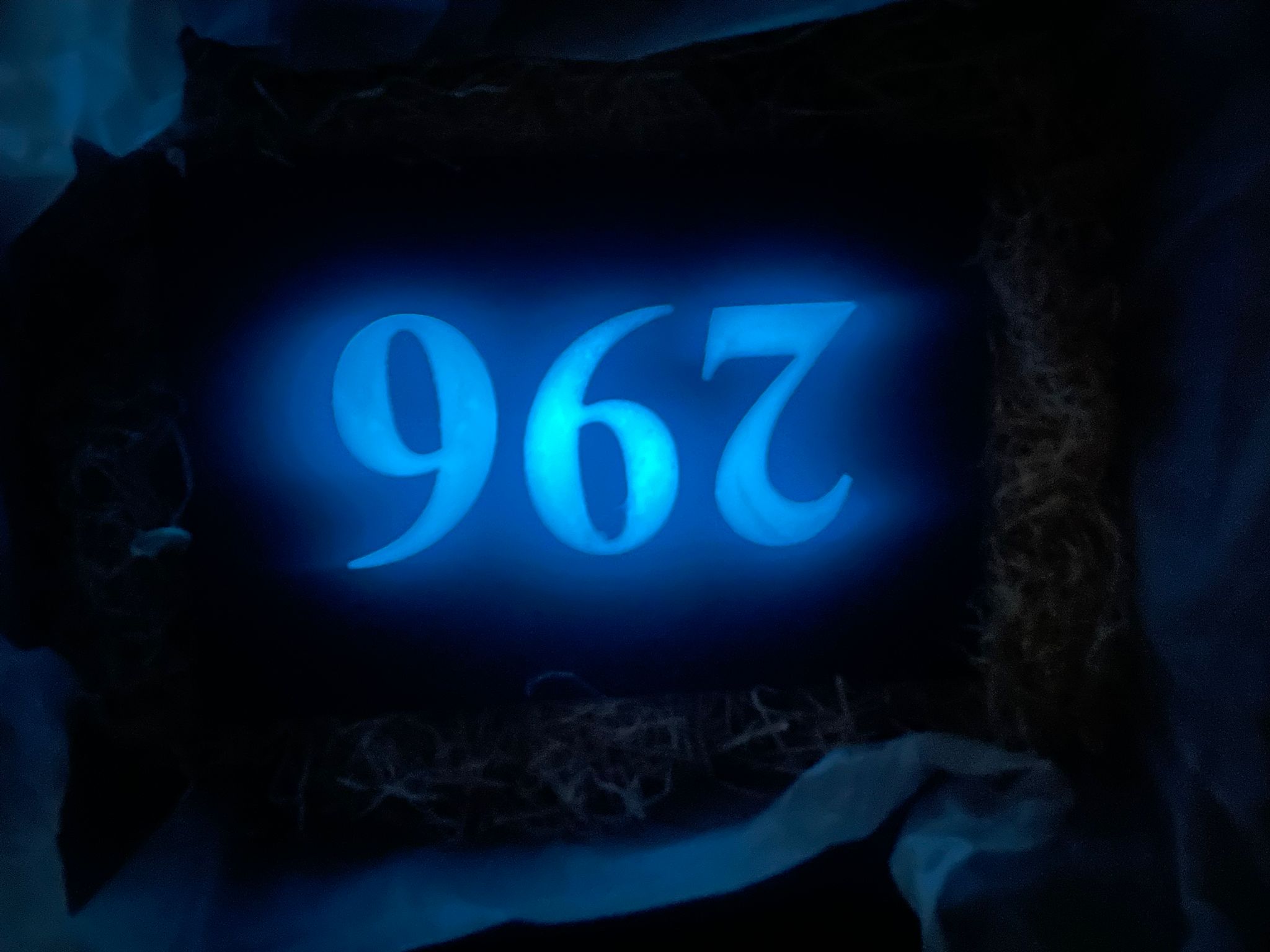 Waymark reflective slate house sign glowing blue at night