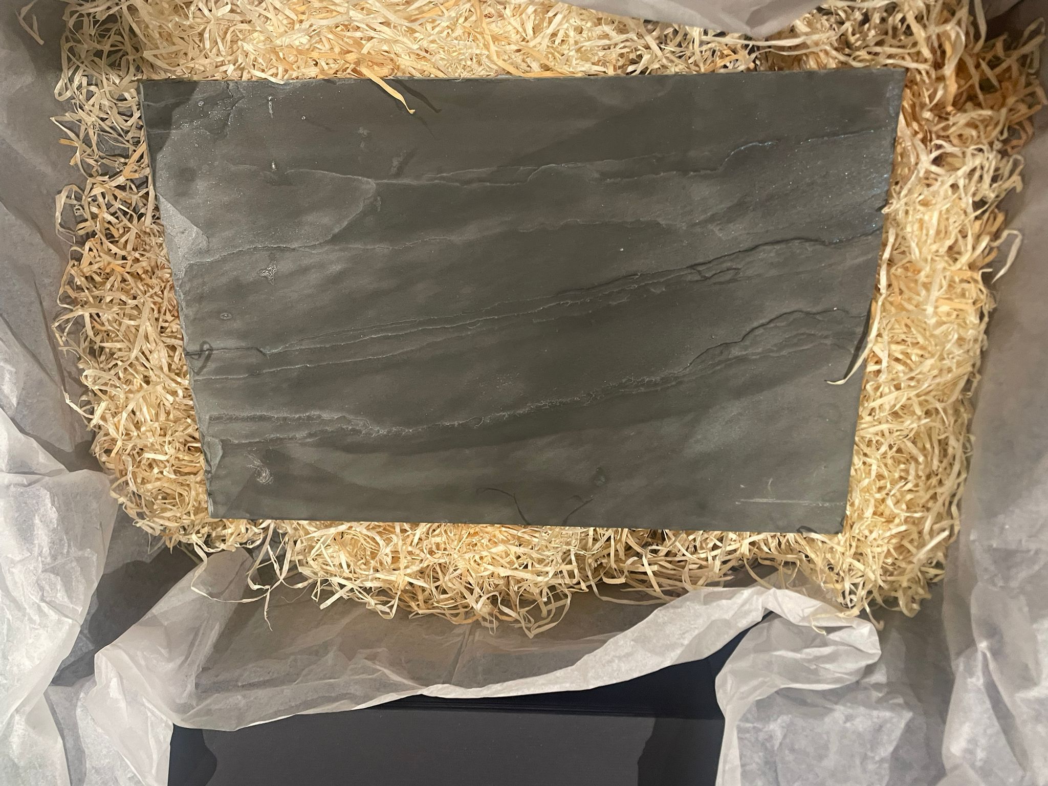 Grey Welsh slate house sign installed on exterior wall